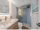 Modern bathroom features a vanity with LED mirror and a glass-enclosed shower with tile accents at 825 S Gulfview Blvd # 104, Clearwater Beach, FL 33767