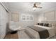 Comfortable bedroom featuring a large bed, accent chair, and a modern ceiling fan at 825 S Gulfview Blvd # 104, Clearwater Beach, FL 33767