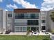 Beautiful waterfront condo exterior featuring private patios with stylish patio furniture and meticulous landscaping at 825 S Gulfview Blvd # 104, Clearwater Beach, FL 33767