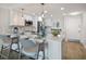 Modern kitchen featuring bright white cabinetry, stainless steel appliances, and stylish bar seating at 825 S Gulfview Blvd # 104, Clearwater Beach, FL 33767
