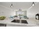 Kitchen island with stainless sink and seating area, featuring water view at 825 S Gulfview Blvd # 104, Clearwater Beach, FL 33767