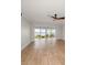 Bright living room with wood floors and sliding glass doors leading to an outdoor seating area and water view at 825 S Gulfview Blvd # 104, Clearwater Beach, FL 33767