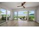 Bright living area features tile floors and sliding doors leading to a waterfront patio with beautiful water views at 825 S Gulfview Blvd # 104, Clearwater Beach, FL 33767