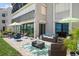 Beautiful outdoor patio area with comfortable seating, decorative rugs and a view of the water at 825 S Gulfview Blvd # 104, Clearwater Beach, FL 33767