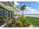 Charming patio with patterned umbrella, lush landscaping, and open ocean views at 825 S Gulfview Blvd # 104, Clearwater Beach, FL 33767