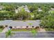 Aerial view of the home showcasing its landscaping, driveway, and surrounding neighborhood at 8319 Annwood Rd, Seminole, FL 33777