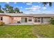 View of the backyard featuring green grass and the rear exterior of the home at 8319 Annwood Rd, Seminole, FL 33777