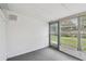 Enclosed bonus room with carpet flooring, a door to the exterior, and screened windows at 8319 Annwood Rd, Seminole, FL 33777