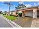 Charming single-story home with an attached garage, well-manicured lawn, and colorful landscaping at 8319 Annwood Rd, Seminole, FL 33777