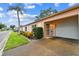 Beautiful single-story home showcasing a well-manicured lawn, vibrant flowers, and an attached garage at 8319 Annwood Rd, Seminole, FL 33777