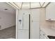 Kitchen featuring white appliances, including a refrigerator with water dispenser, and ample cabinet space at 8319 Annwood Rd, Seminole, FL 33777