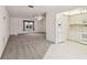 Bright kitchen connected to the living room featuring white cabinetry and appliances at 8319 Annwood Rd, Seminole, FL 33777