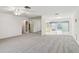 Open living room with neutral carpet, ceiling fan, and views to a dining area and beyond at 8319 Annwood Rd, Seminole, FL 33777