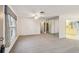 Bright living room featuring neutral carpet, a ceiling fan, and access to the kitchen at 8319 Annwood Rd, Seminole, FL 33777