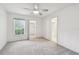 Spacious primary bedroom with neutral carpet, a large window, and ensuite bathroom at 8319 Annwood Rd, Seminole, FL 33777