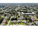 Panoramic aerial view showcasing a residential neighborhood, nearby buildings, and tree coverage at 8671 11Th N St, St Petersburg, FL 33702