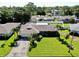 Aerial view of the house showing the roof, driveway and front yard at 8671 11Th N St, St Petersburg, FL 33702