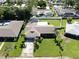 Aerial view of a well-maintained home with a lush lawn and mature landscaping at 8671 11Th N St, St Petersburg, FL 33702