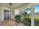 Inviting front porch with tiled flooring, a modern front door, and manicured landscaping at 8671 11Th N St, St Petersburg, FL 33702