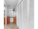 Charming hallway featuring built-in cabinetry, a mirror, and a lovely light fixture at 8671 11Th N St, St Petersburg, FL 33702