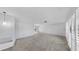 Bright and airy living room with neutral walls, plush carpeting, and shuttered windows at 8671 11Th N St, St Petersburg, FL 33702
