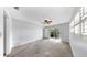 Bright main bedroom featuring neutral walls, carpet flooring, and access to the backyard at 8671 11Th N St, St Petersburg, FL 33702