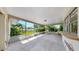 Covered porch with a view of the landscaped backyard at 8671 11Th N St, St Petersburg, FL 33702