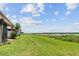 Expansive backyard with lush green grass and views of a serene lake at 9209 Seminole Blvd # 13, Seminole, FL 33772