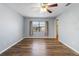 Bedroom with light blue walls, ceiling fan, wood floors, and a window at 9209 Seminole Blvd # 13, Seminole, FL 33772