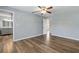 Bedroom with ceiling fan, wood floors, and a view into the en suite bathroom at 9209 Seminole Blvd # 13, Seminole, FL 33772
