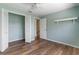 Bedroom with wood floors, blue walls, and bi-fold closet doors at 9209 Seminole Blvd # 13, Seminole, FL 33772