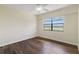 Bedroom with neutral walls, wood floors, and window overlooking the water at 9209 Seminole Blvd # 13, Seminole, FL 33772