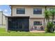 Home exterior with screened in lanai, lush landscaping, and brick patio at 9209 Seminole Blvd # 13, Seminole, FL 33772