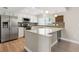 Bright kitchen with stainless steel appliances, white cabinets, and eat-in bar at 9209 Seminole Blvd # 13, Seminole, FL 33772