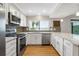 Bright kitchen features stainless steel appliances, white cabinets, and a stunning view at 9209 Seminole Blvd # 13, Seminole, FL 33772