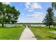 Pathway leads to a scenic dock overlooking the calm lake at 9209 Seminole Blvd # 13, Seminole, FL 33772