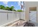 Enclosed patio with white privacy fence and a patterned outdoor rug at 9209 Seminole Blvd # 13, Seminole, FL 33772