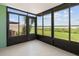 Enclosed sunroom features black frame windows overlooking a beautiful lawn at 9209 Seminole Blvd # 13, Seminole, FL 33772