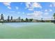 View of well-maintained community tennis courts and surrounding landscape at 9209 Seminole Blvd # 13, Seminole, FL 33772