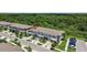 Aerial view of modern townhomes with well-manicured lawns and convenient parking in a Gathering friendly community at 9768 Pembrooke Pines Dr, Sun City Center, FL 33573