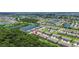 Extensive aerial view of townhome community, featuring mature trees, water features, and Gathering-friendly green spaces at 9768 Pembrooke Pines Dr, Sun City Center, FL 33573