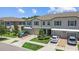 Aerial view of well-maintained townhomes with manicured lawns and driveway parking at 9768 Pembrooke Pines Dr, Sun City Center, FL 33573