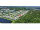 Wide aerial view of a large townhome community near lakes and ponds, boasting mature tree growth at 9768 Pembrooke Pines Dr, Sun City Center, FL 33573