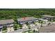 Aerial view of newer townhomes with attached garages, surrounded by lush green trees and landscaping at 9768 Pembrooke Pines Dr, Sun City Center, FL 33573