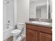Well-lit bathroom with granite countertops and tub and shower combination at 9768 Pembrooke Pines Dr, Sun City Center, FL 33573