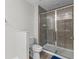 Bathroom with walk-in shower featuring glass doors and tiled walls at 9768 Pembrooke Pines Dr, Sun City Center, FL 33573