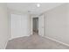 A serene bedroom with a ceiling fan, plush carpet, and double door closet at 9768 Pembrooke Pines Dr, Sun City Center, FL 33573