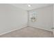 Bright bedroom featuring plush carpet, ceiling fan, and window with an inviting view at 9768 Pembrooke Pines Dr, Sun City Center, FL 33573
