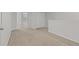 Spacious bonus room with neutral carpeting, white trim and baseboards, and an abundance of natural light at 9768 Pembrooke Pines Dr, Sun City Center, FL 33573