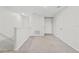 Bright bonus room with neutral walls, carpet, and white trim, creating a versatile and inviting space at 9768 Pembrooke Pines Dr, Sun City Center, FL 33573